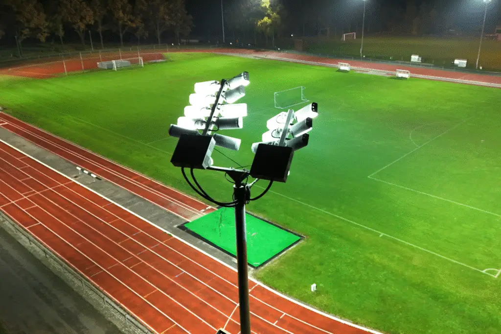 LED fixtures on a lighting pole that powerfully and evenly illuminate an athletic track.